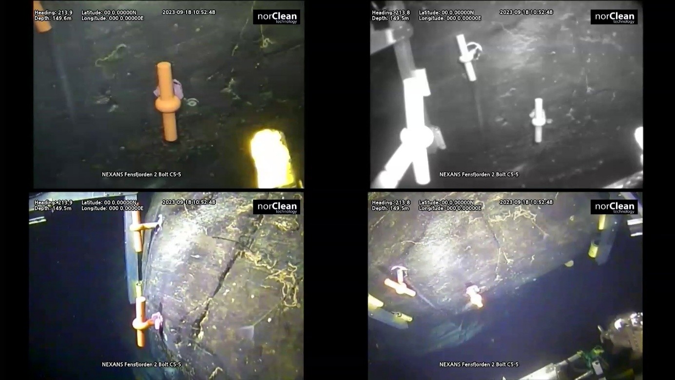 High-voltage subsea cable secured to underwater rock with steel clamps and bolts
