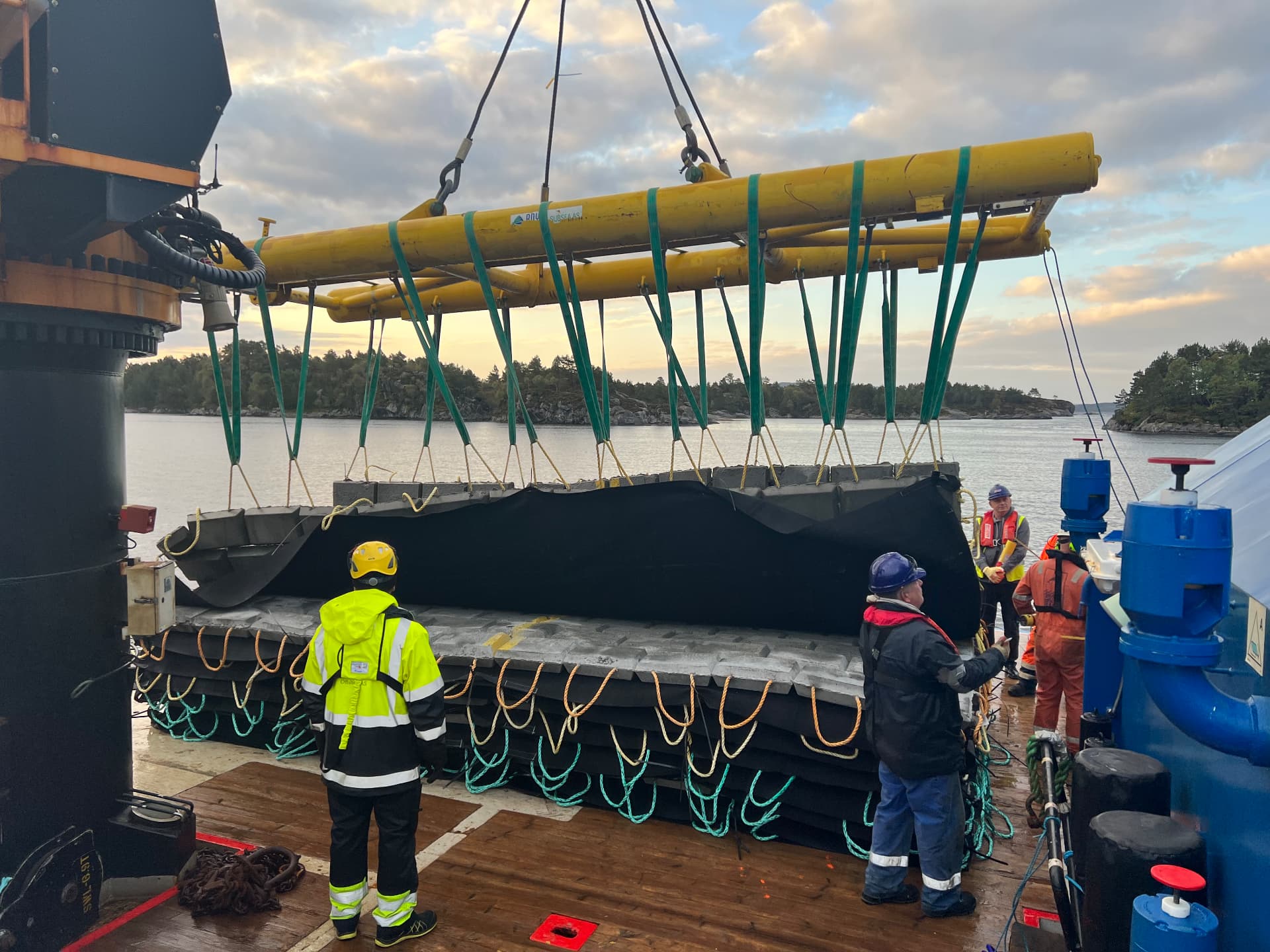 Concrete mattress lifted on a spreader beam before installation at the cable landfall