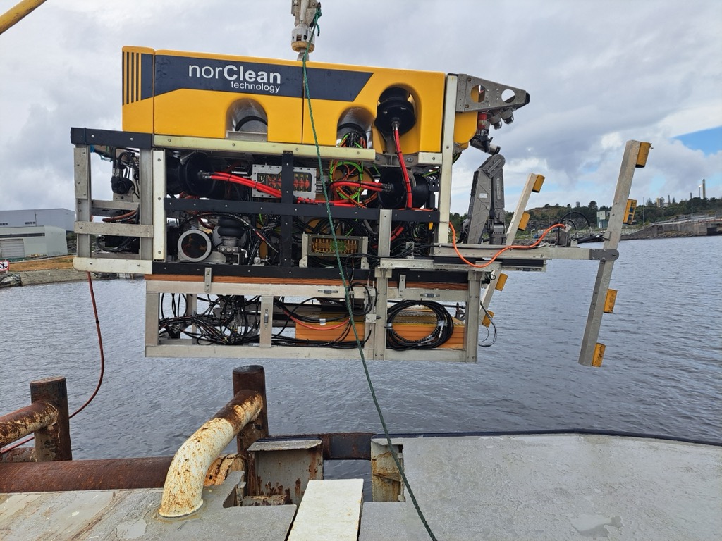 NorClean work-class ROV lifted out over the water from the quay